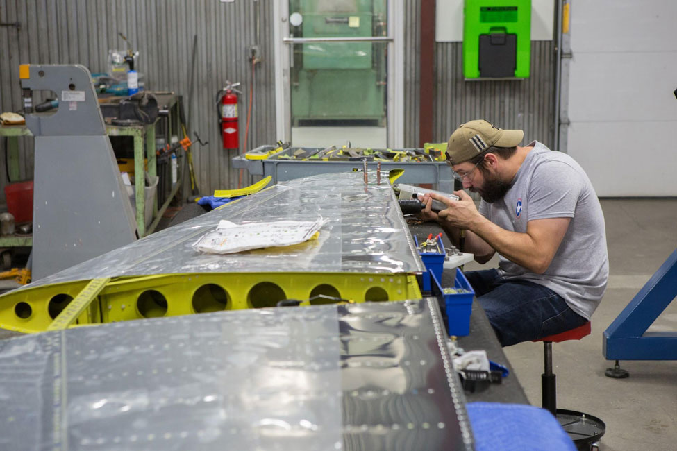 Randy using a rivet squeezer to get some of the last rivets into tight quarters on the stabilizer.