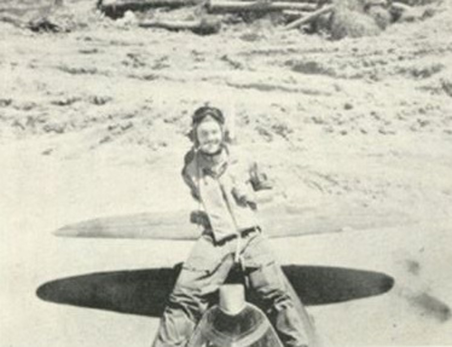 Lt. Searles sits astride the rear fuselage of Little Chum.