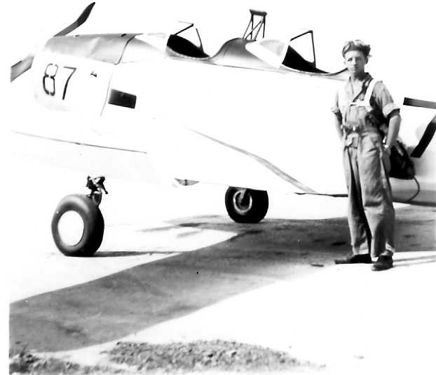 Cadet Don McKenna stands in front of a PT-19 during primary flight training.